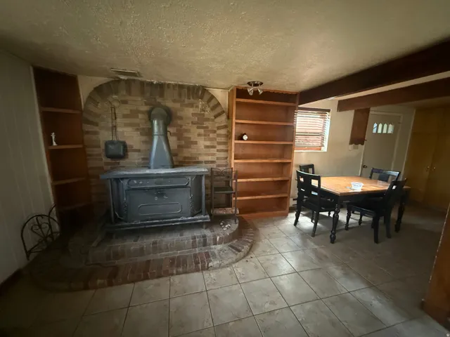 Brick hearth with a wood-burning stove and a brick archway