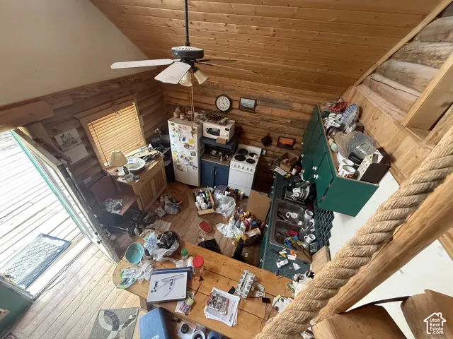 Vaulted wood-paneled ceilings with exposed beams, wood-finish flooring, and horizontal wood paneling