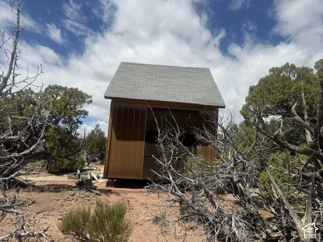 Wood-sided structure with a shingled gable roof