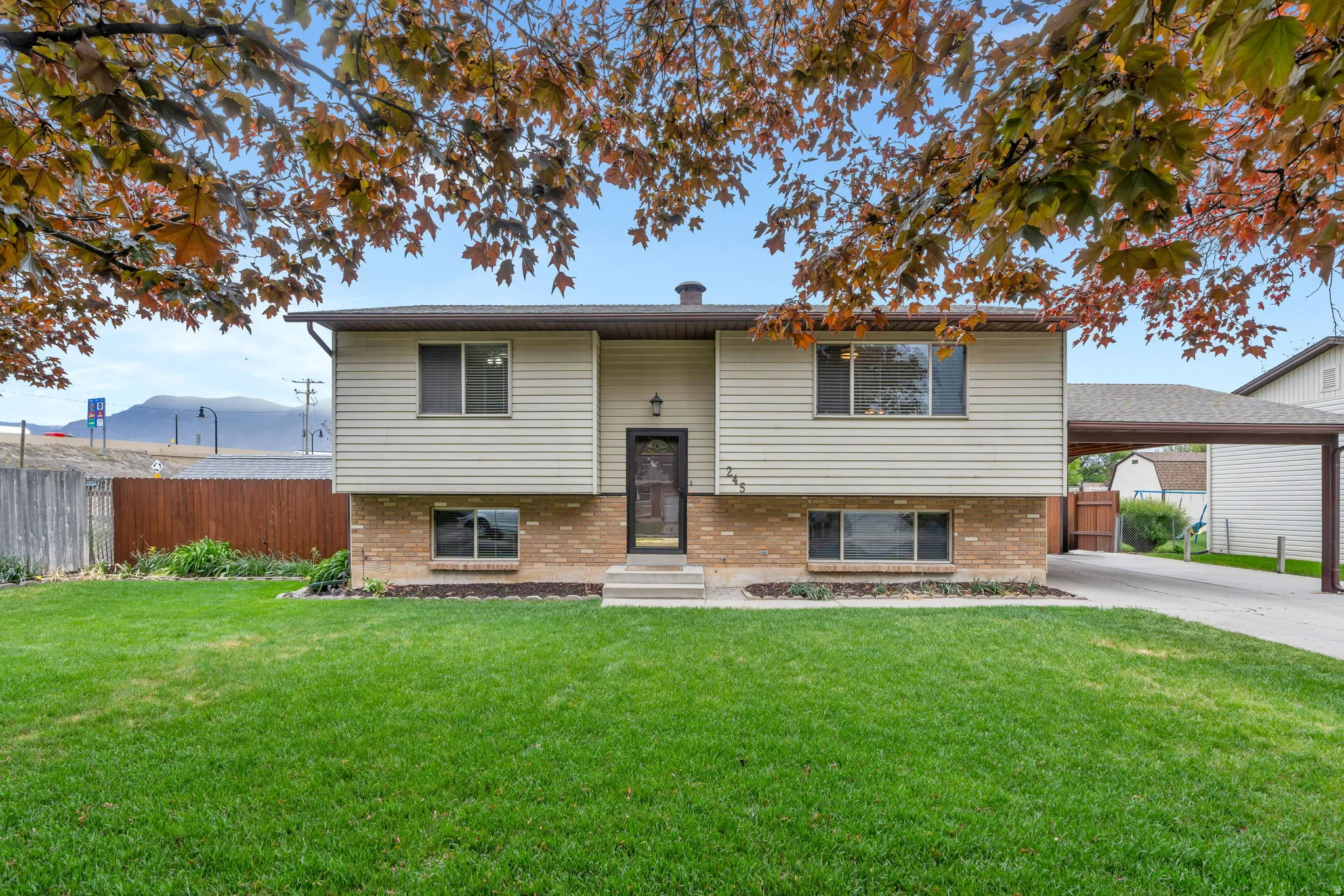 Split-level residence featuring a brick and siding exterior