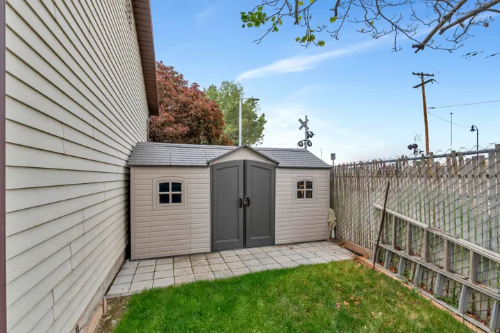 Outdoor storage shed featuring double doors and small windows