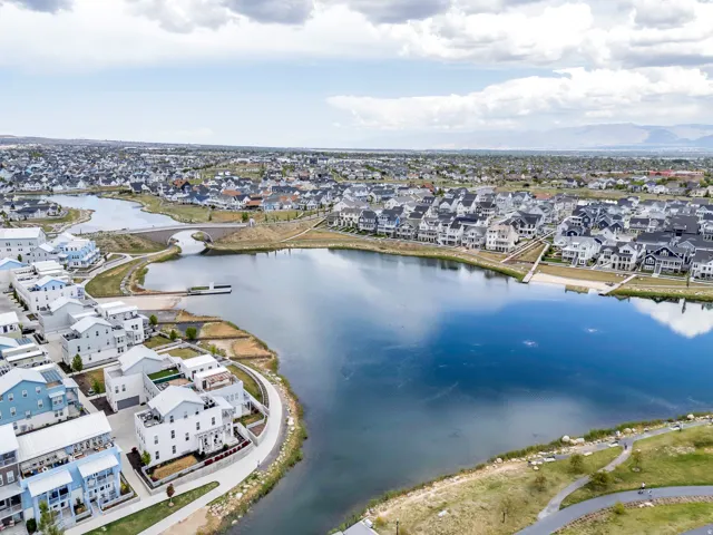 Aerial perspective showcasing a residential area featuring a central lake