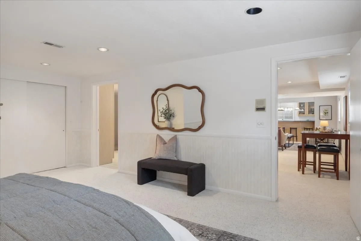 Carpeted interior with recessed lighting and white walls