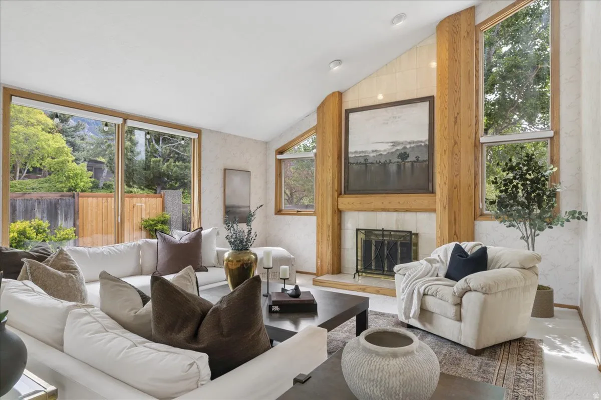 Living area featuring a vaulted ceiling with recessed lighting