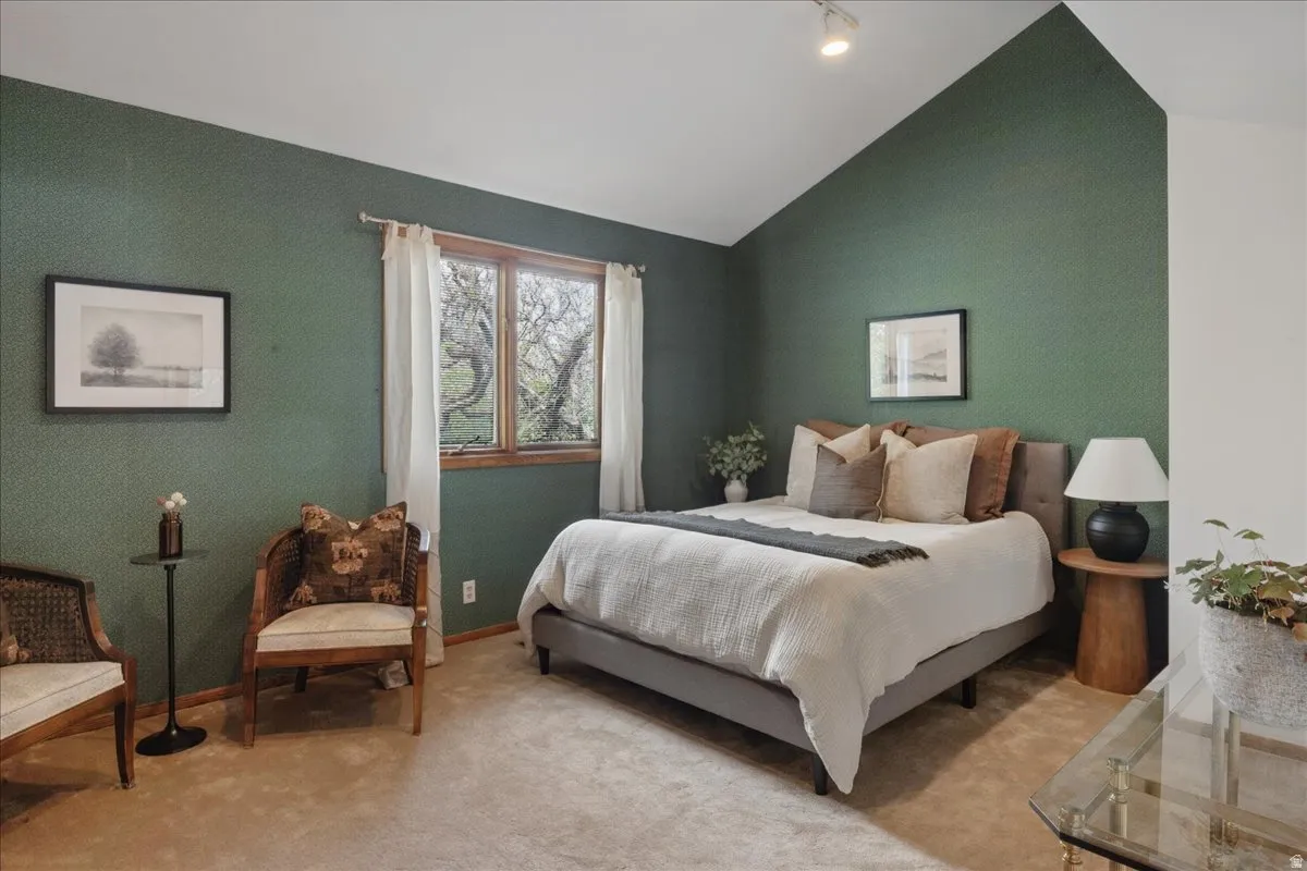 Room with vaulted ceiling and track lighting