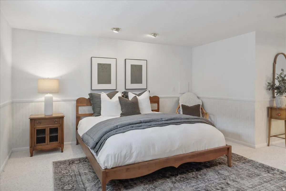 Neutral wall paint with paneling detail and recessed lighting