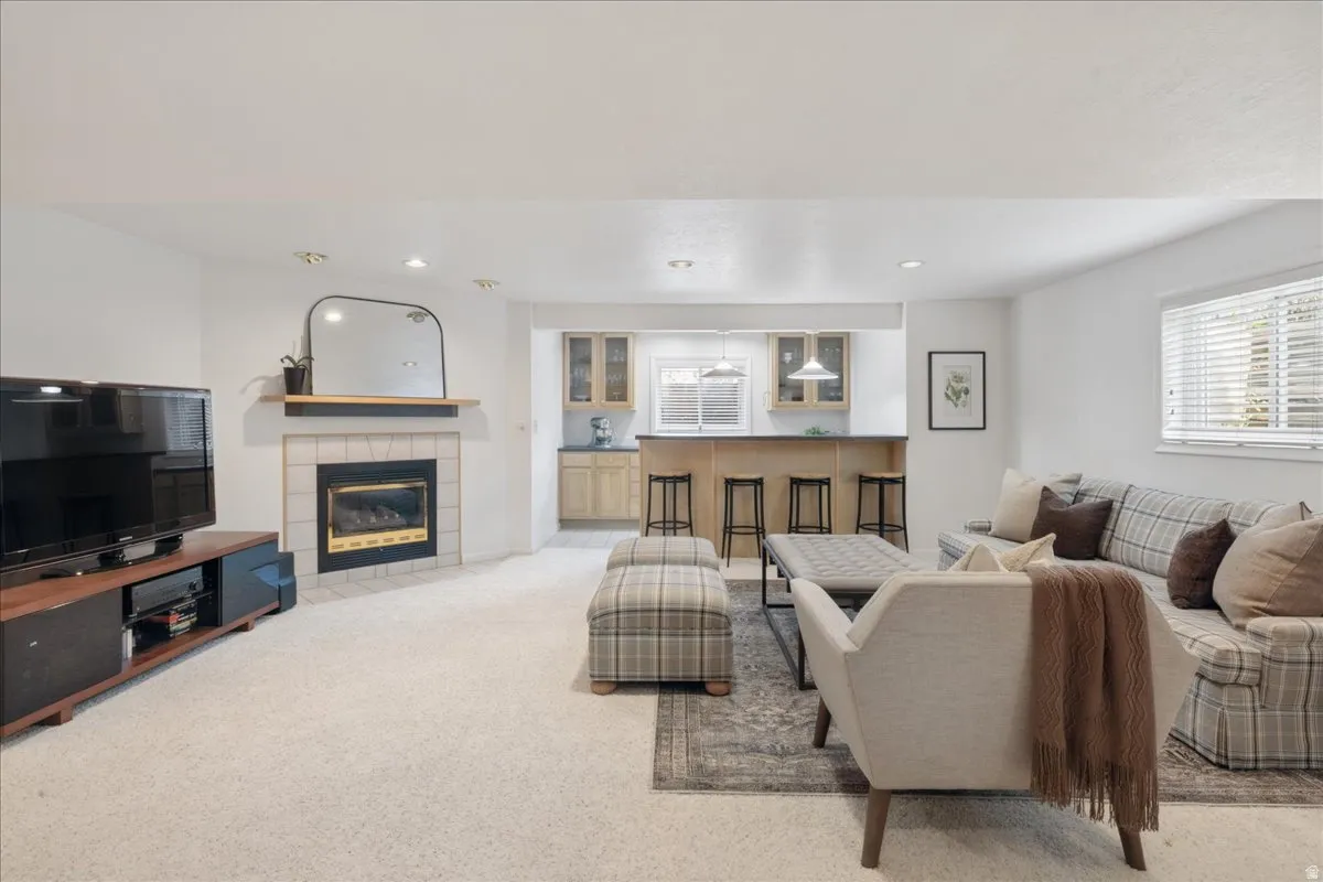 Spacious living area featuring a built-in fireplace with a tile surround and wood mantel