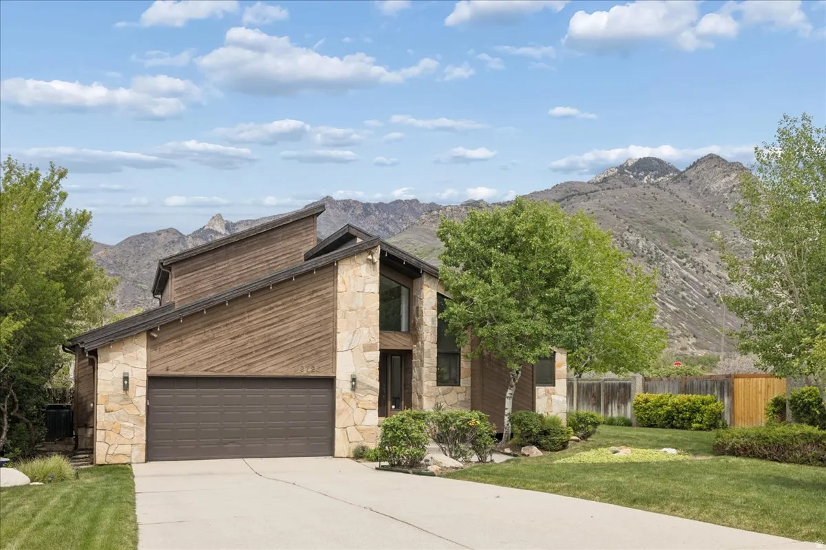 Contemporary architectural design featuring stone and wood-finish siding