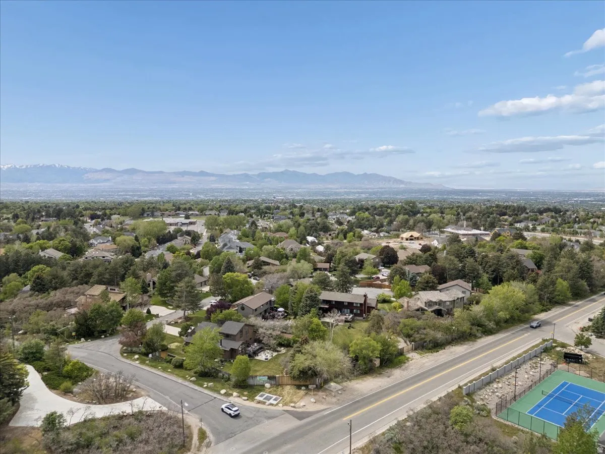 Aerial perspective showcasing a residential area with extensive tree cover