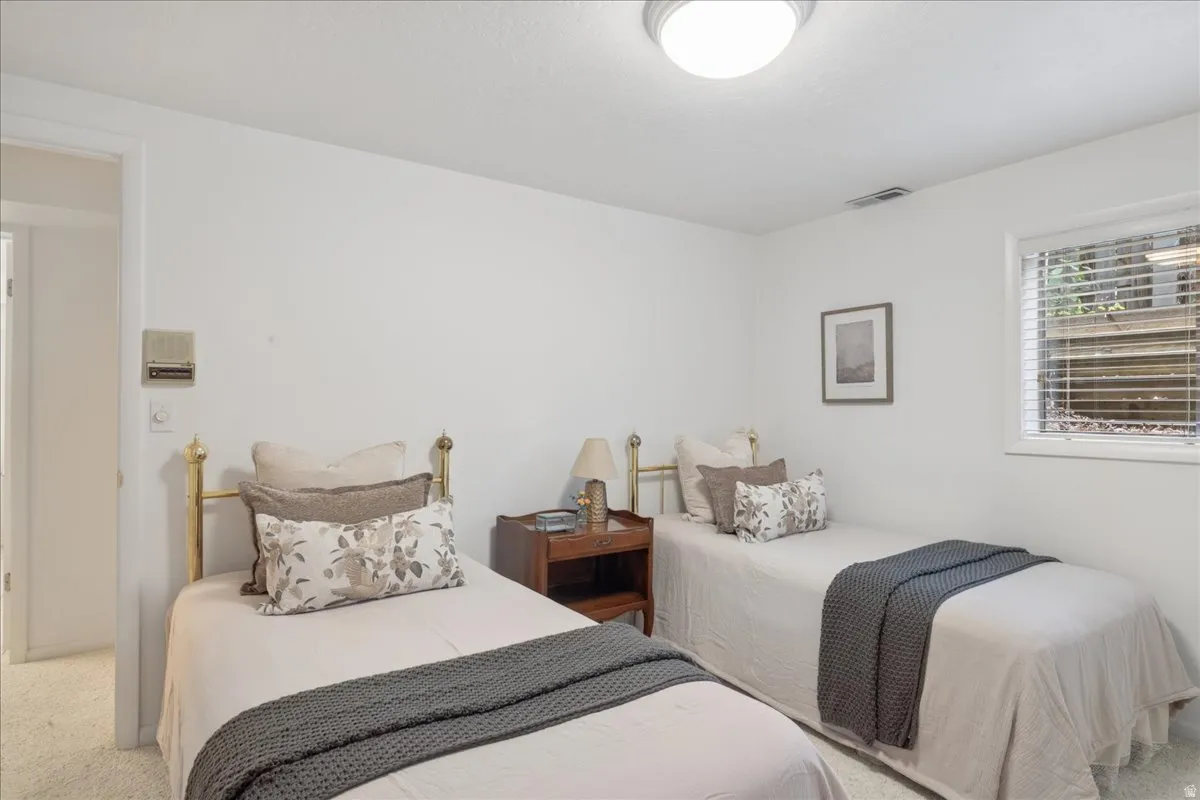 Bright room featuring white walls, a flush-mount ceiling light, and a window with blinds