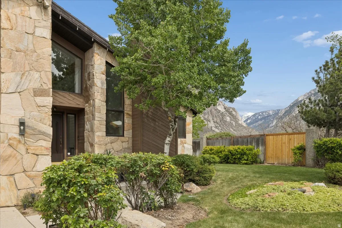 Stone veneer exterior featuring large windows and a double entry door