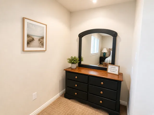 Warm neutral wall color, recessed ceiling lighting, and carpeted flooring