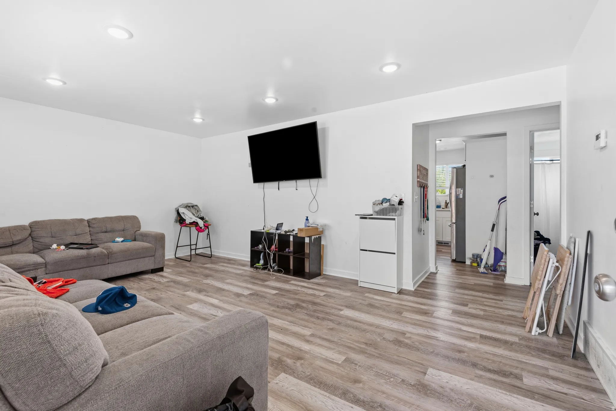 Expansive interior room featuring recessed lighting, light wood-finish flooring, and white walls