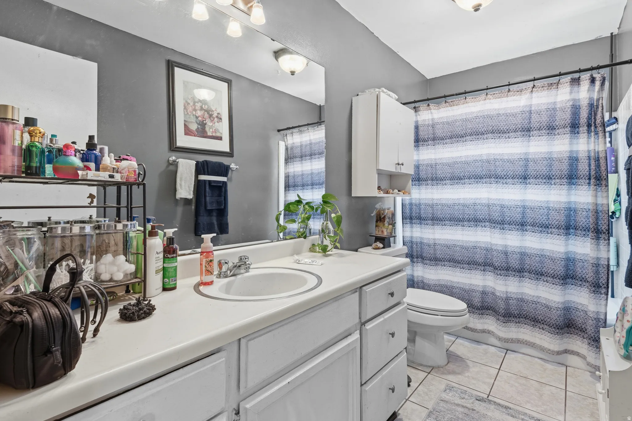 White vanity with an integrated sink, polished chrome faucet, and ample storage cabinetry