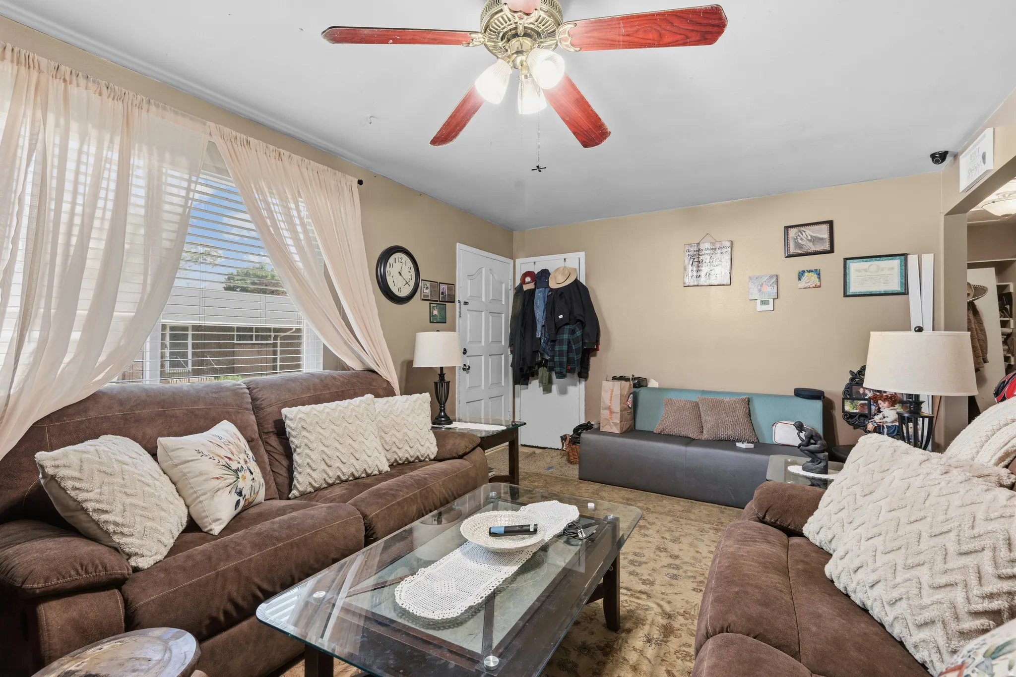 Living area featuring a textured ceiling with a ceiling fan