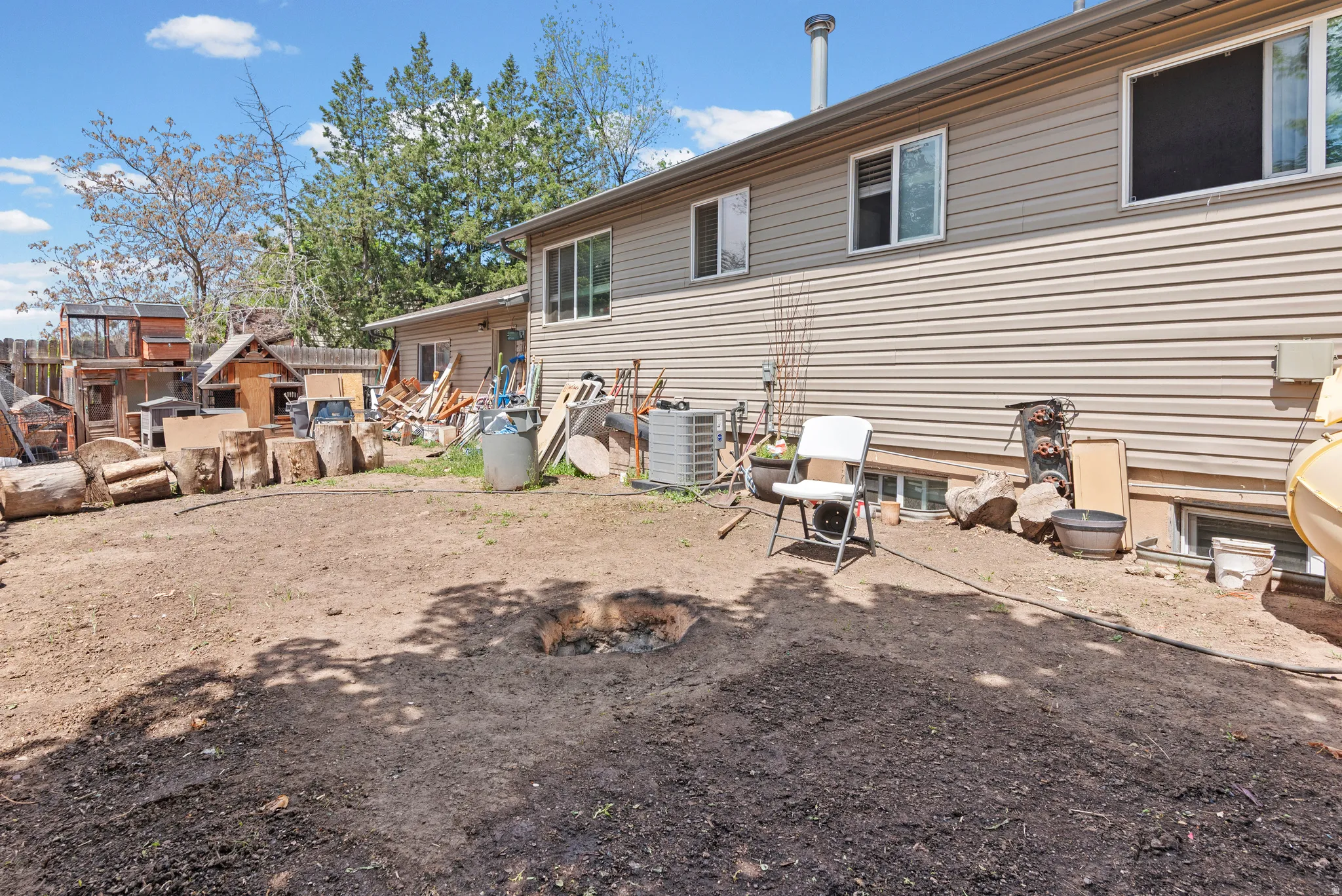 Expansive backyard area with a large earth patch