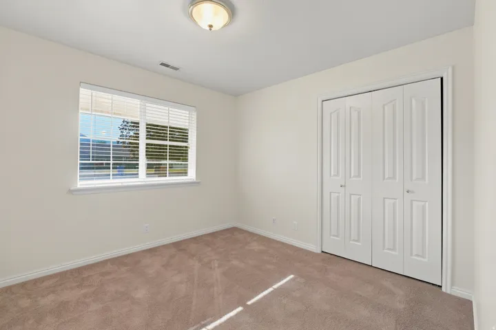 Neutral tone carpeting paired with light-colored walls and white trim