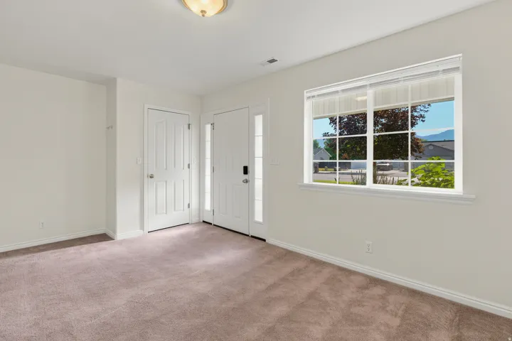 Front entry area featuring a paneled door, sidelight windows, and a flush mount ceiling light