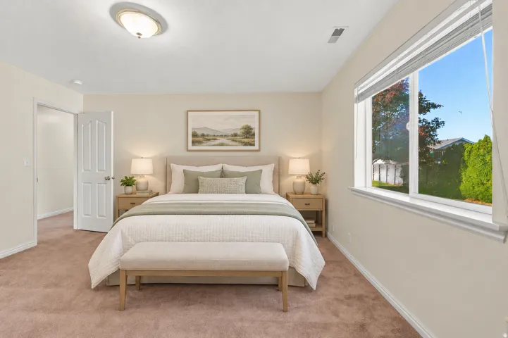 Neutral-toned walls complement the plush carpeting