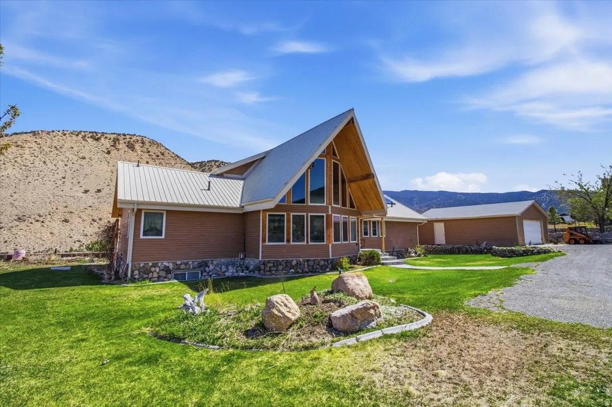 A-frame home featuring a metal roof and large picture windows