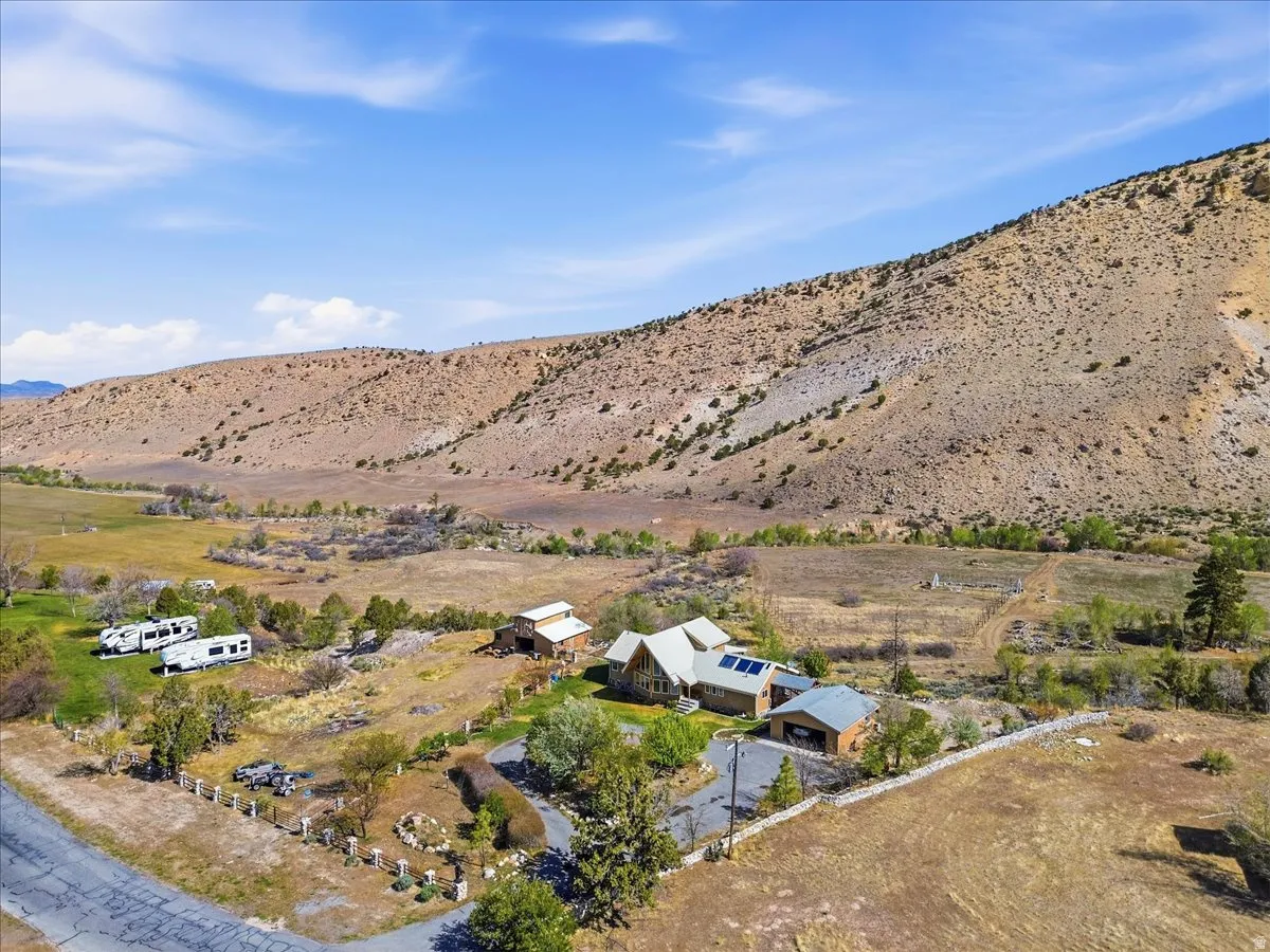 Ranch-style residence with a distinctive multi-gable roofline and attached garage, complemented by solar panels