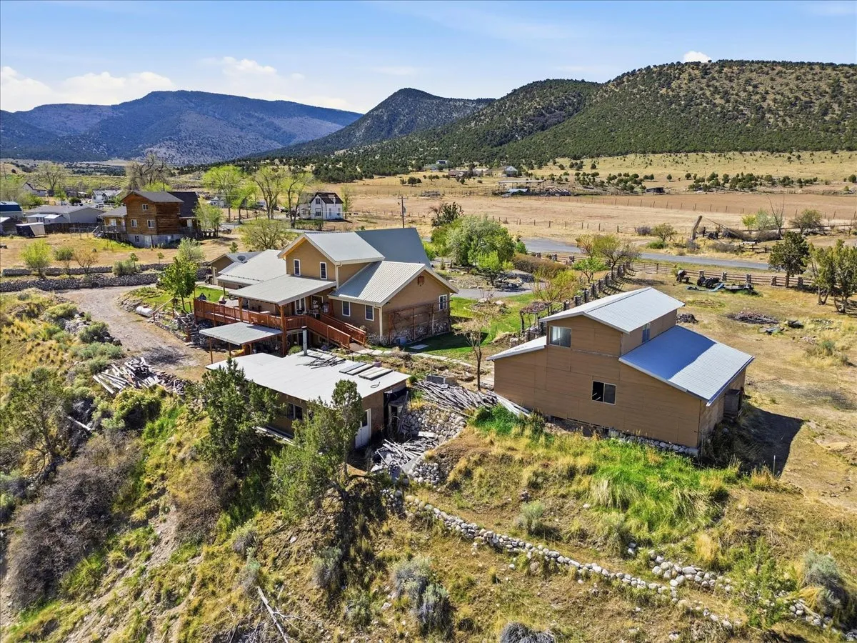 Terraced property with multiple structures featuring mountain and valley backdrops