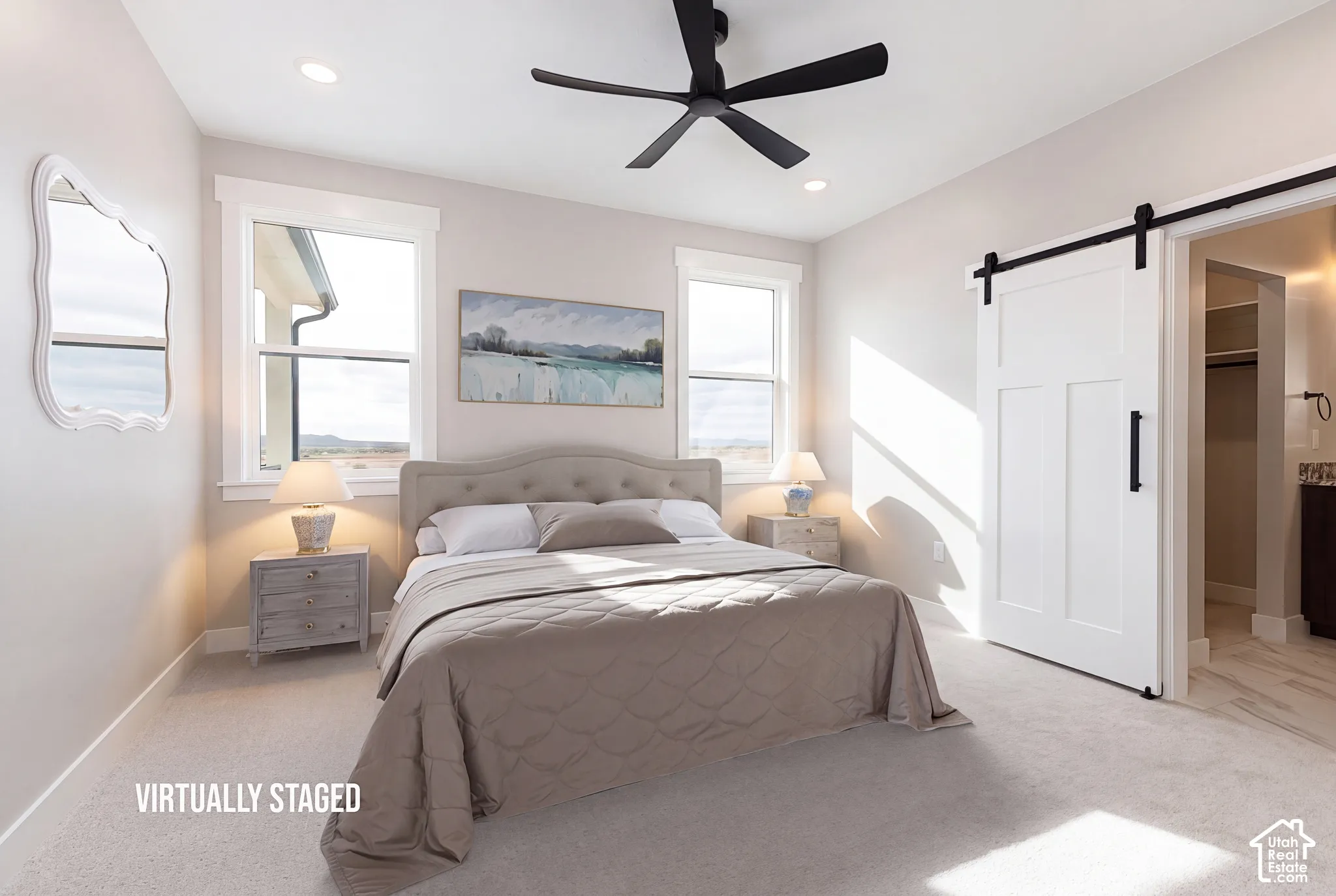 Recessed lighting, ceiling fan, carpeted flooring, and a white barn door with black hardware