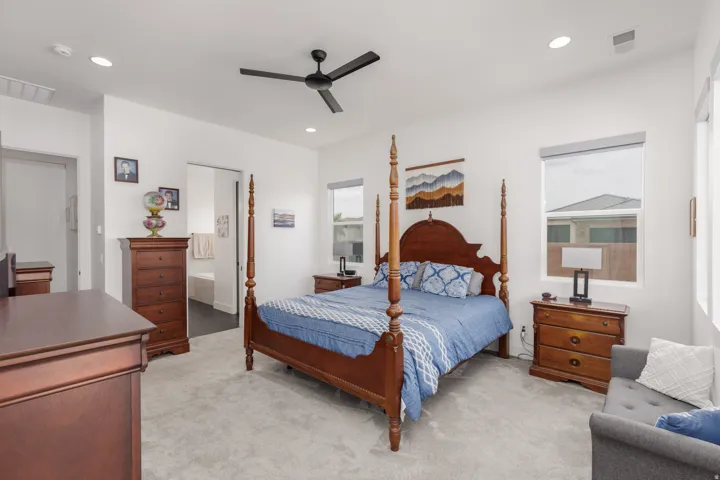 Carpeted room featuring recessed lighting, a ceiling fan, and multiple windows