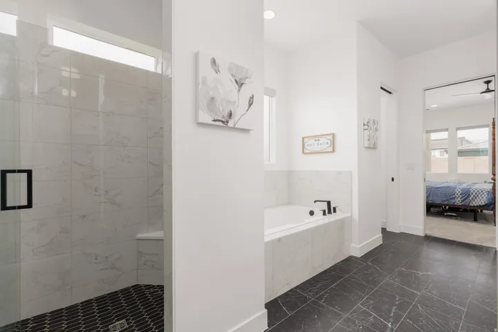 Contemporary bathroom featuring a spacious walk-in shower with clear glass enclosure and a built-in bench