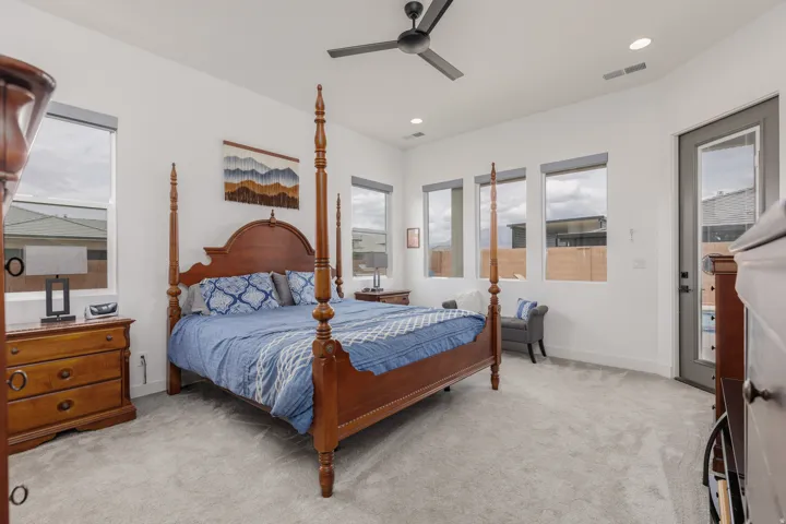 Spacious room featuring light gray carpeting and white walls