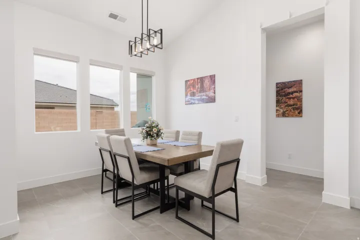 Spacious interior featuring a vaulted ceiling and rectangular tile flooring