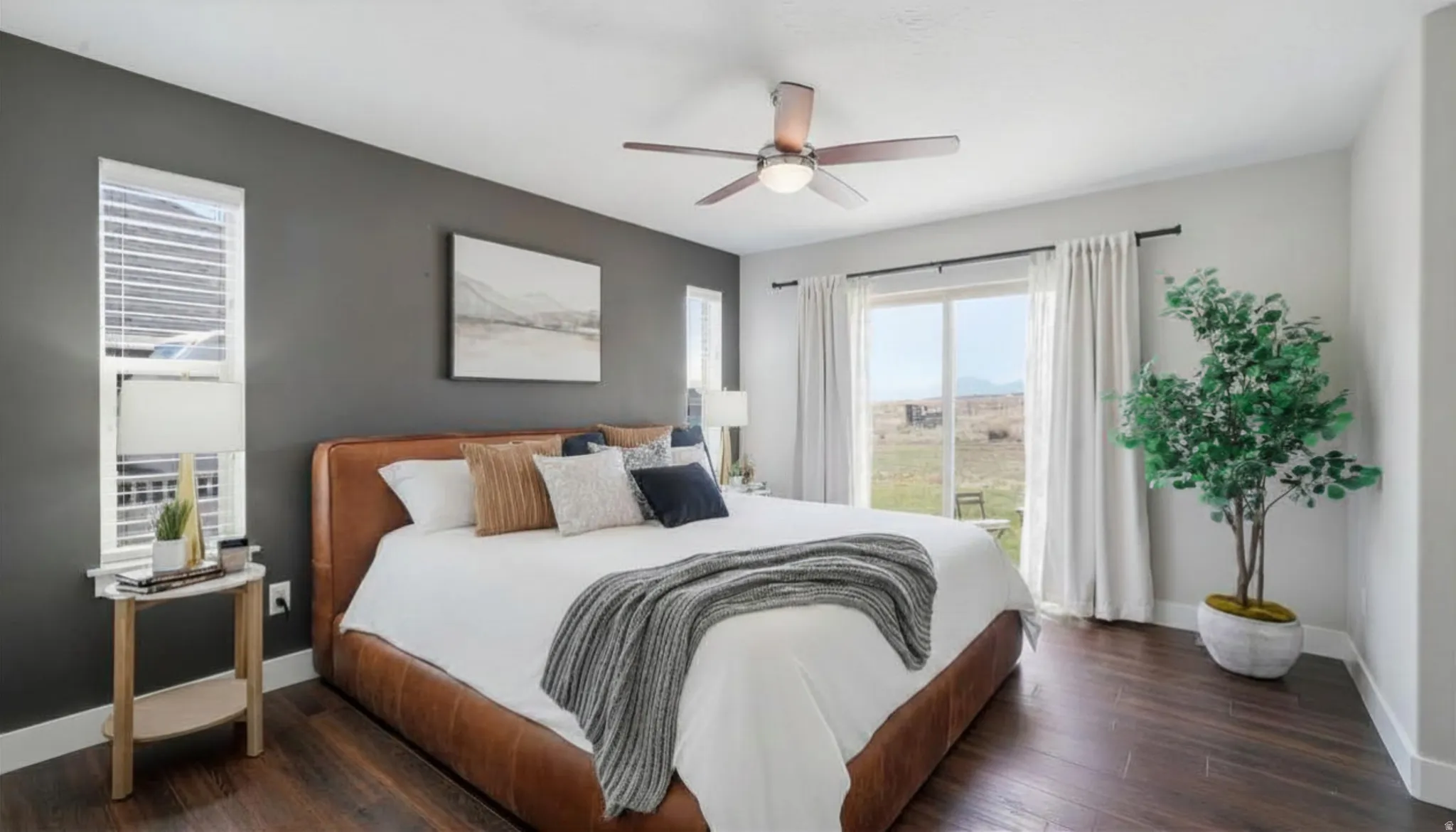 Bedroom featuring dark wood-finish flooring, a contemporary ceiling fan, and a sliding glass door to patio area