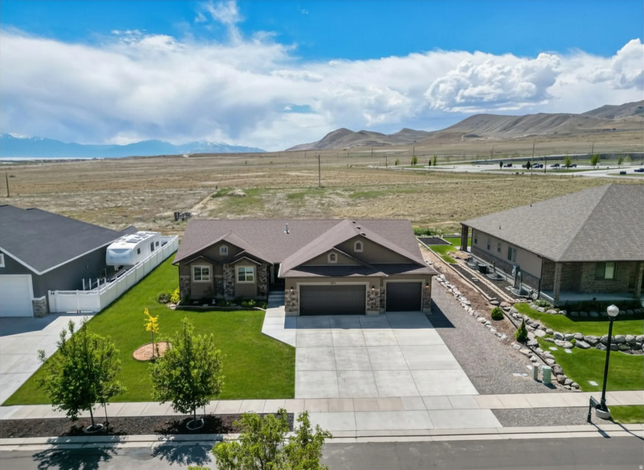 Ranch-style residence featuring a stone and siding facade, and a concrete driveway
