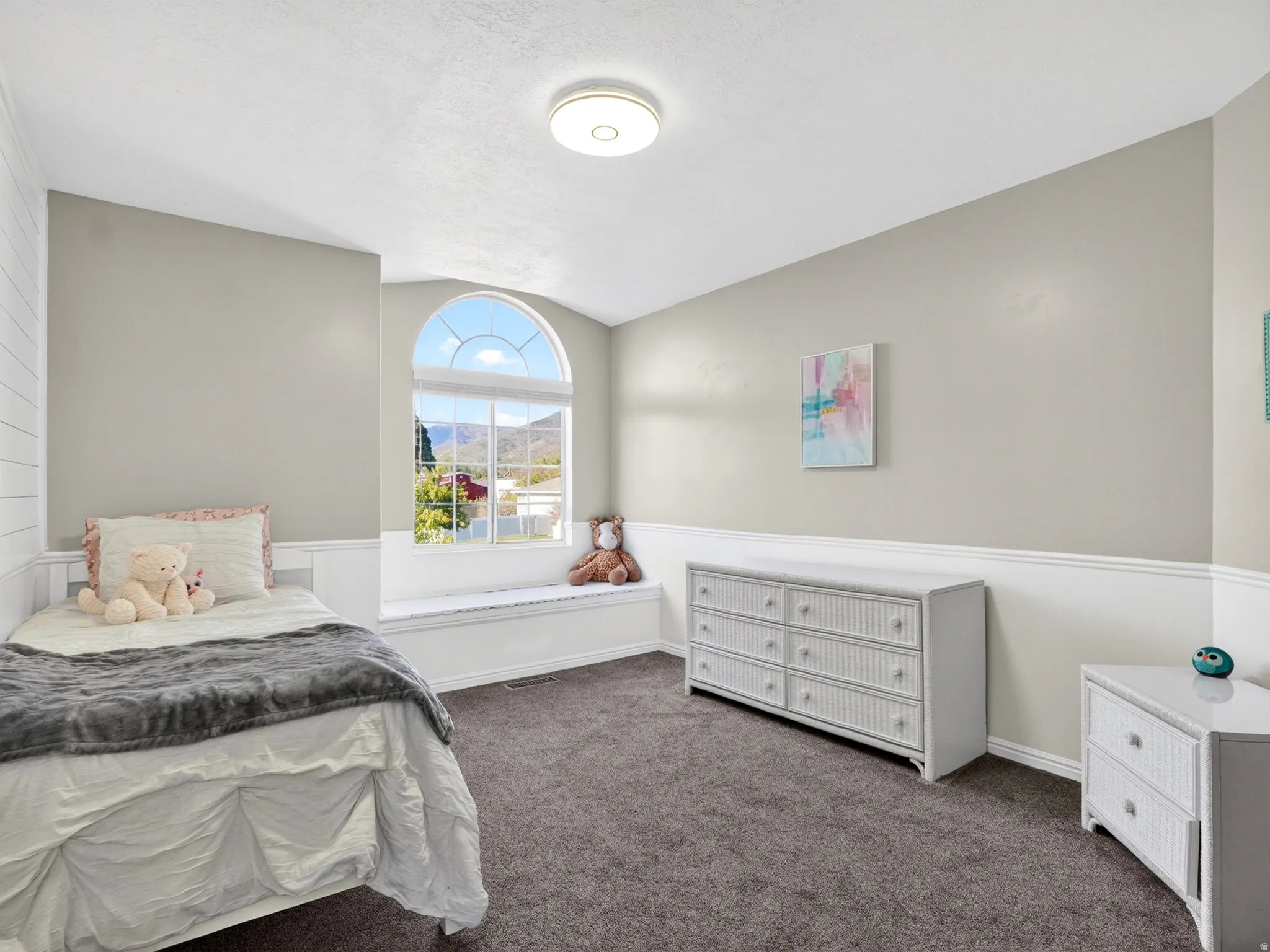 Arched window with mountain scenery and a built-in window seat