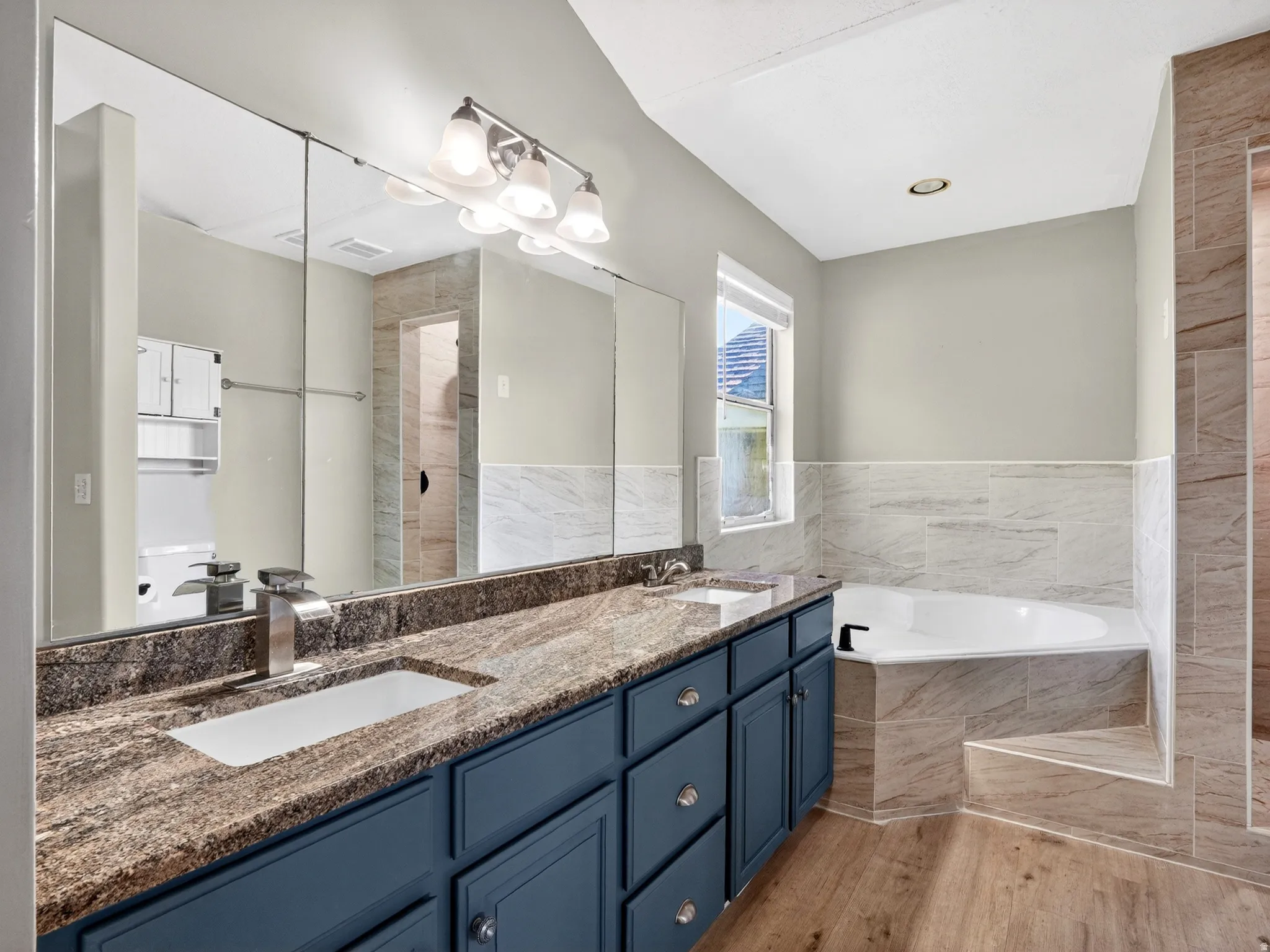 Dual vanity featuring a stone countertop and undermount sinks