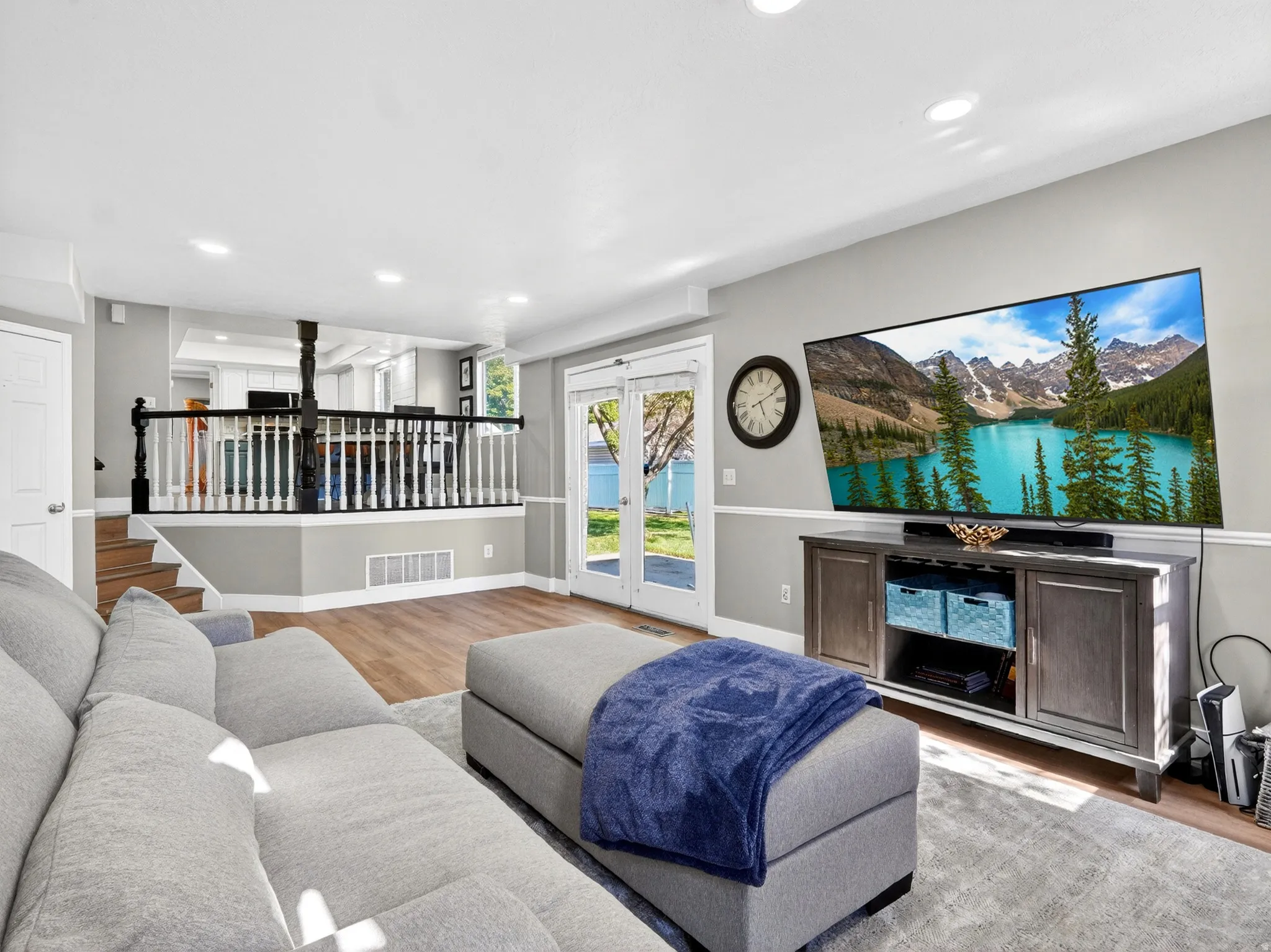 Spacious living area featuring wood-finish flooring, recessed lighting, and a white ceiling