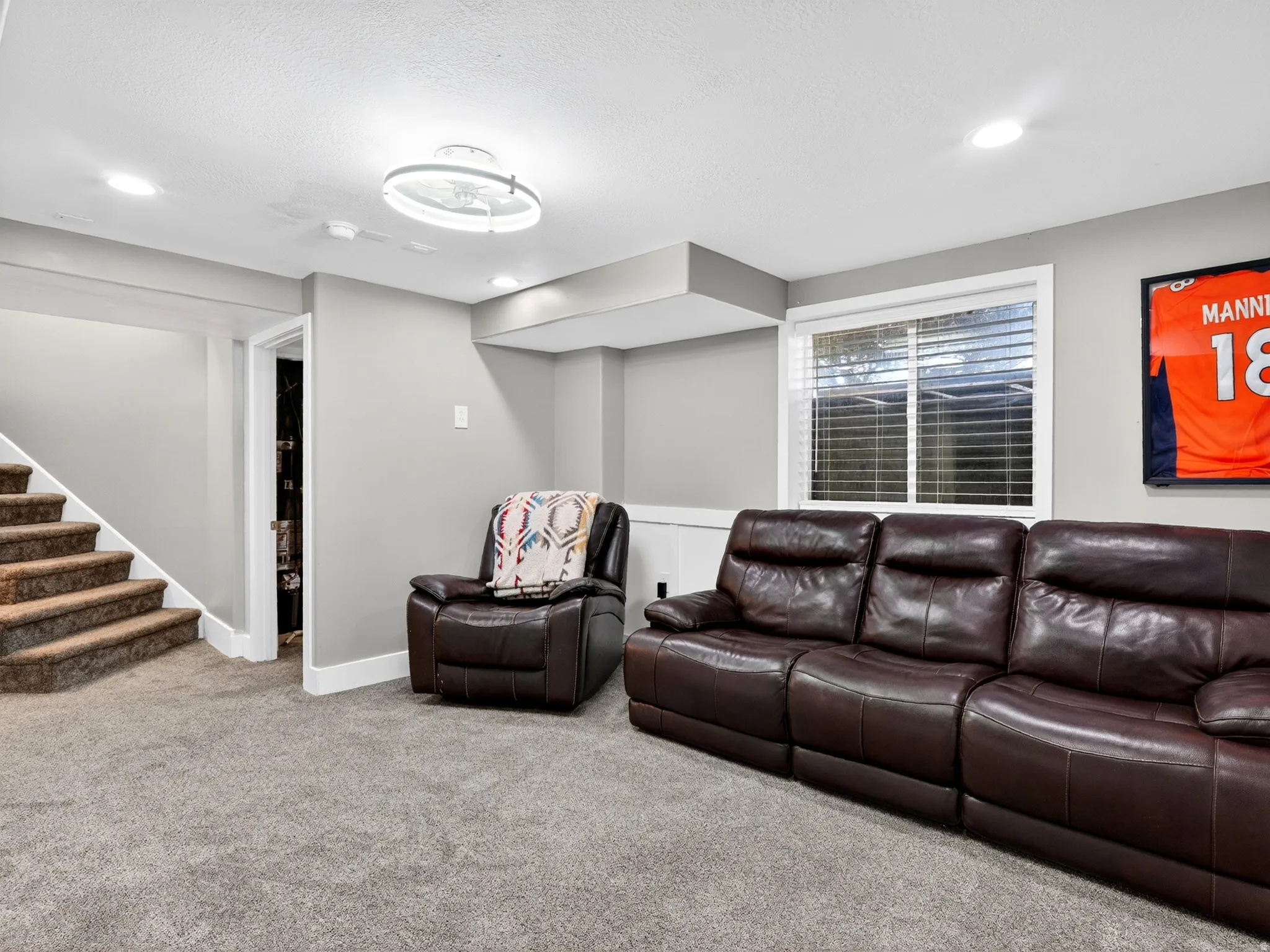 Carpeted room with light gray walls, recessed lighting, and a contemporary ceiling fixture