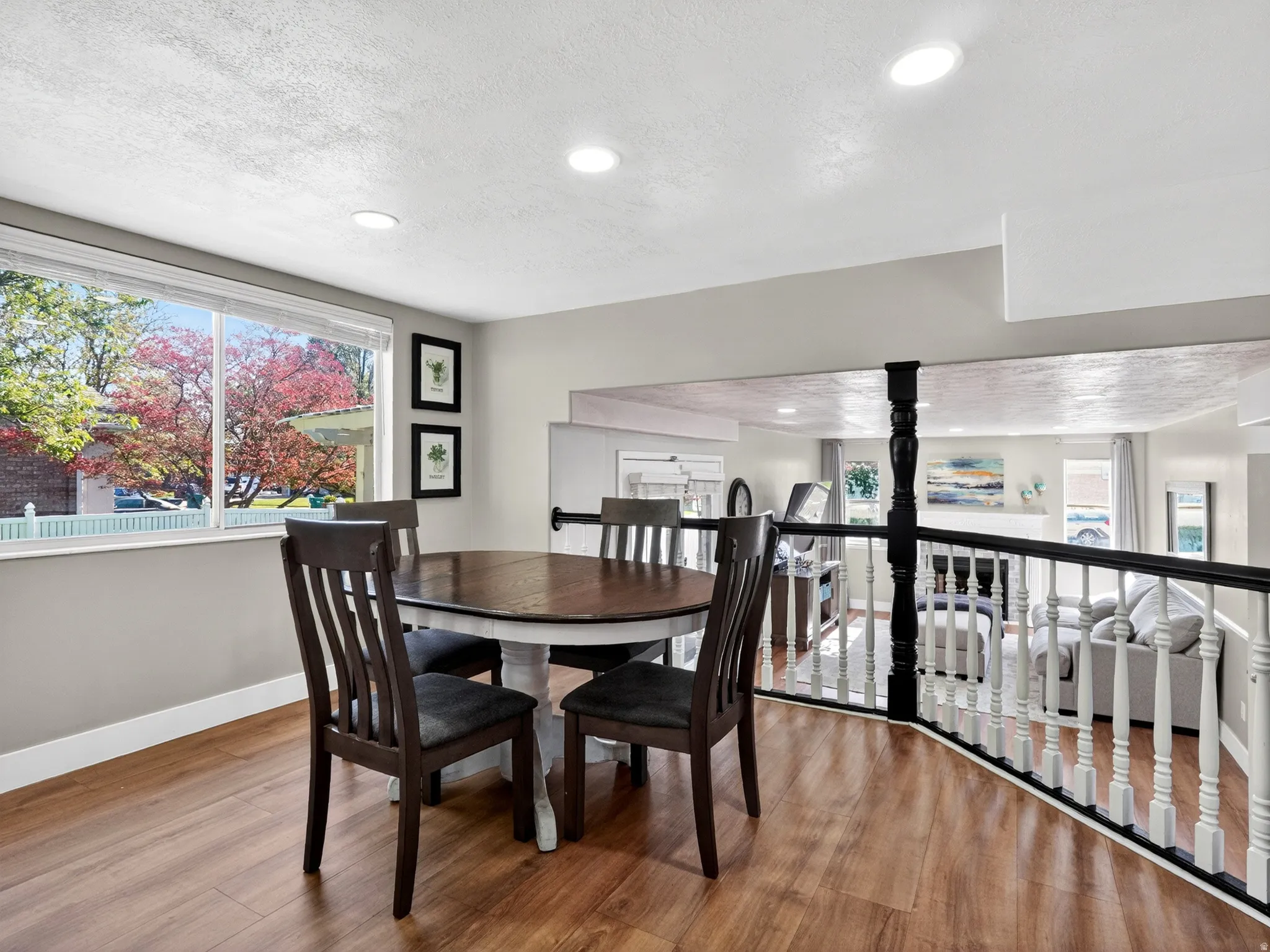 Dining area featuring wood-finish flooring, recessed lighting, and a large picture window