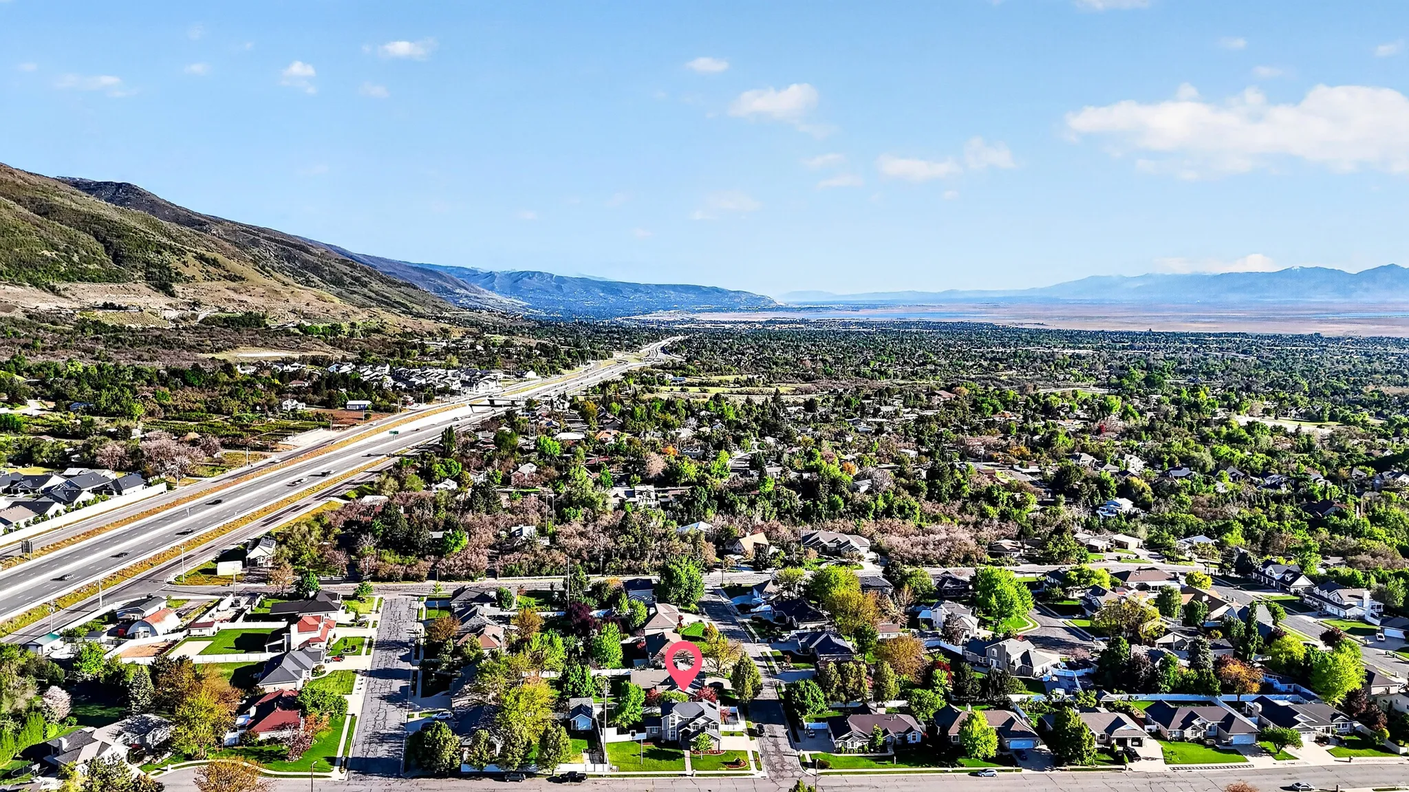 Residential neighborhood featuring a prominent highway and mountain range