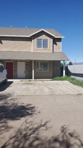 Two-story property featuring horizontal siding and stone veneer accents