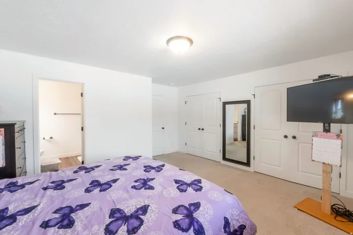 Bedroom featuring light beige carpet flooring and white painted walls