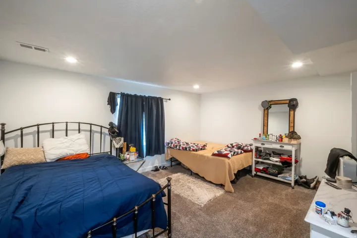 Spacious room featuring neutral carpeting, recessed lighting, and light-toned wall finishes