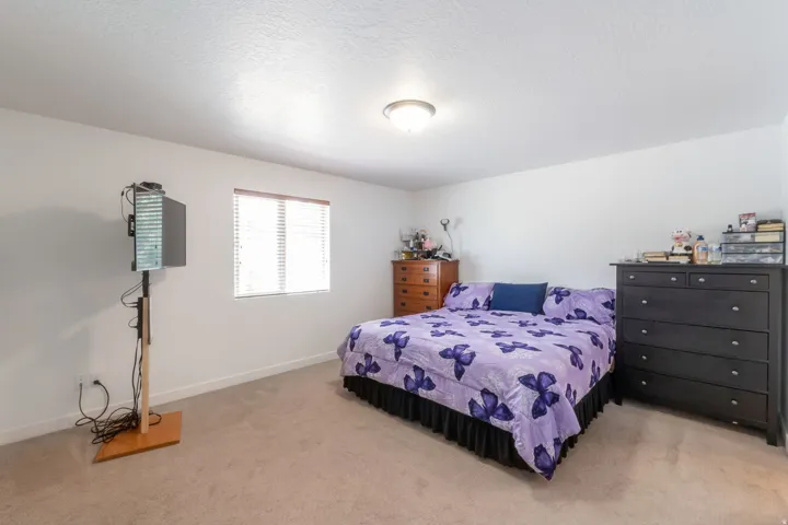 Spacious interior room with neutral carpeting and white wall finishes