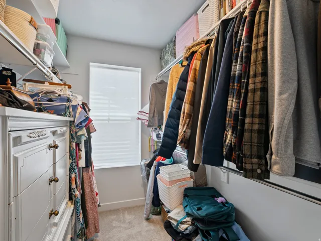 Custom closet system featuring built-in cabinetry, shelving, and hanging rods