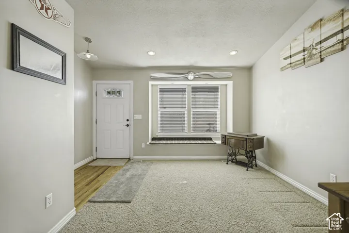 Open space featuring mixed flooring of wood-finish and carpet