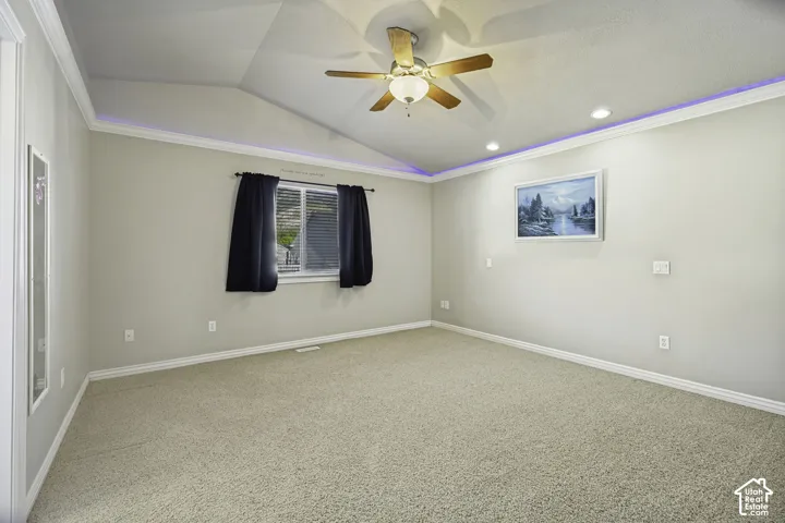 Vaulted ceiling with a ceiling fan, recessed lighting, and accent lighting