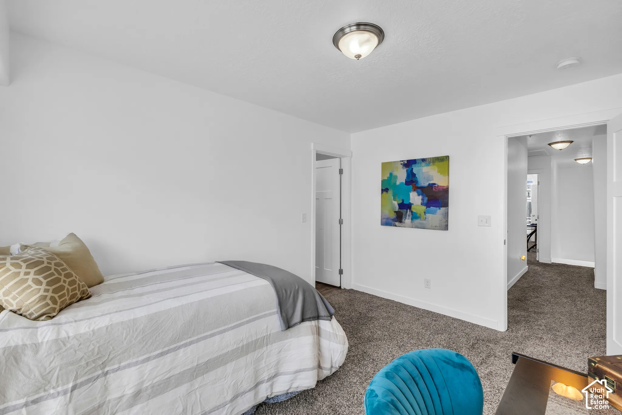 Neutral-toned bedroom with textured carpet flooring