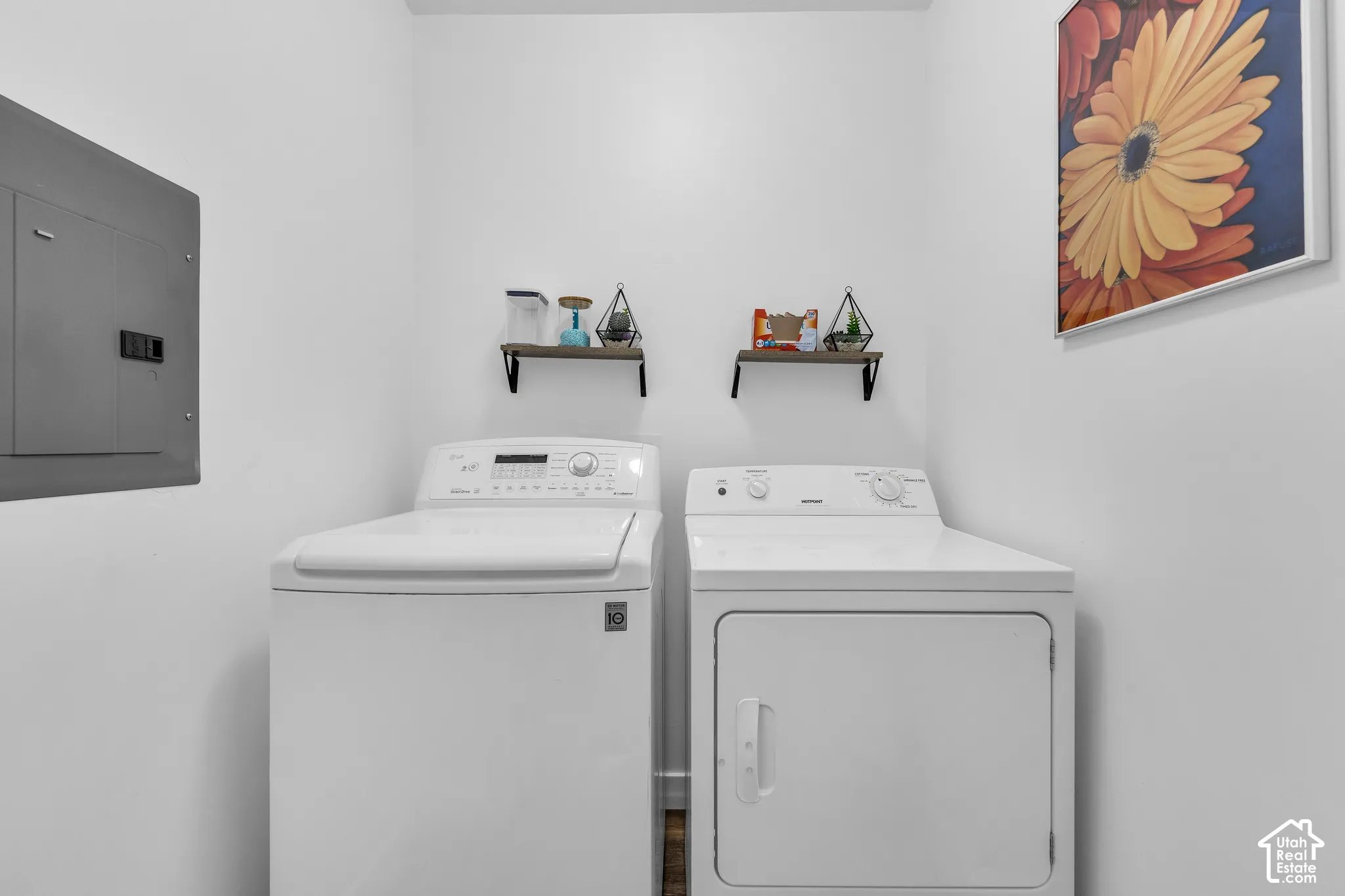 Dedicated laundry space featuring a white top-load washing machine and front-load dryer