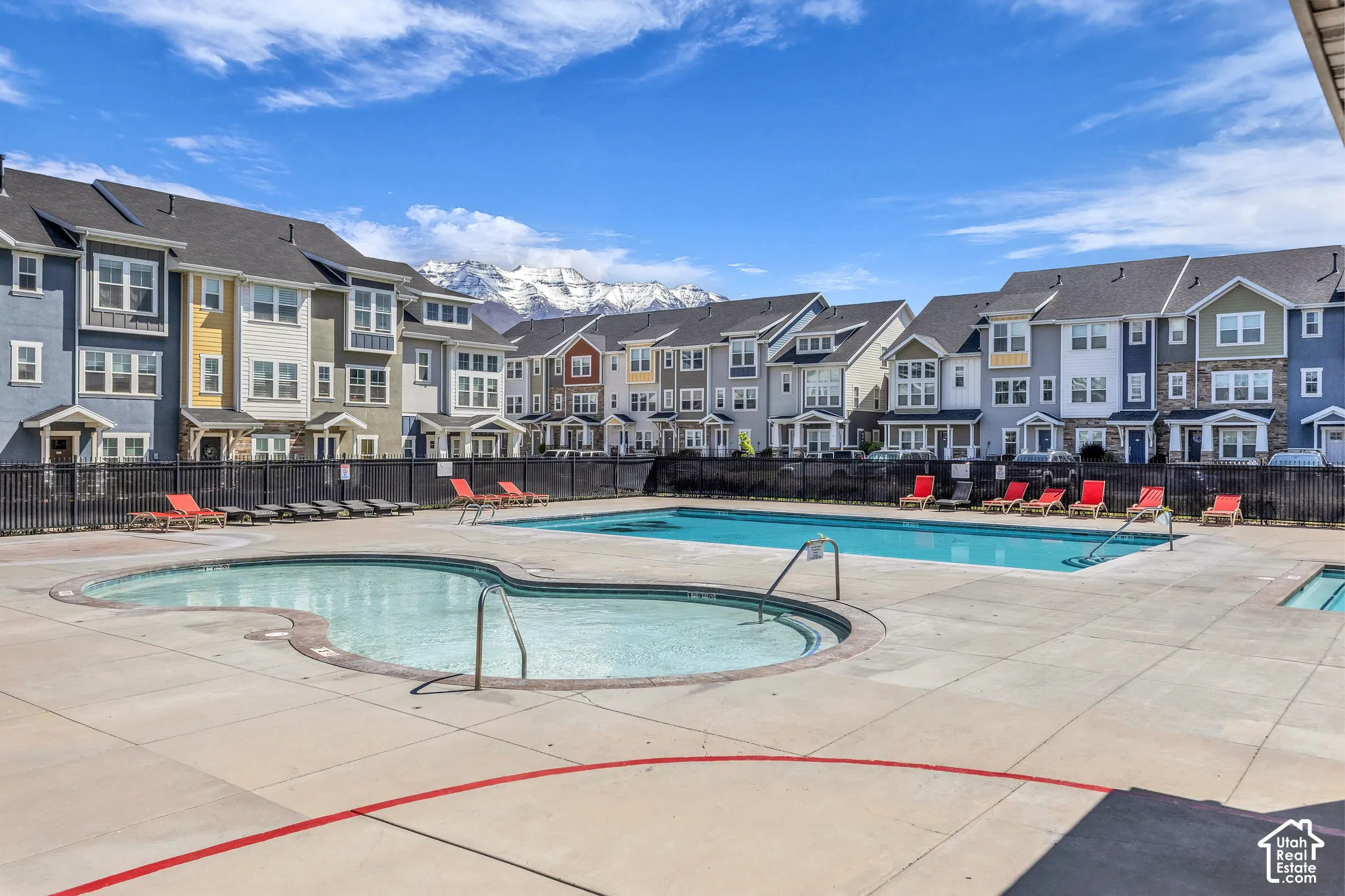 Resort-style pool area featuring two swimming pools and an integrated spa