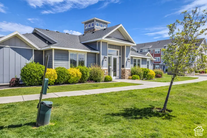 Contemporary multi-unit exterior featuring gray siding, stone accents, and a central cupola